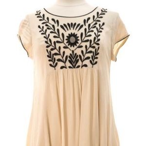 Cream and black detailed short dress.